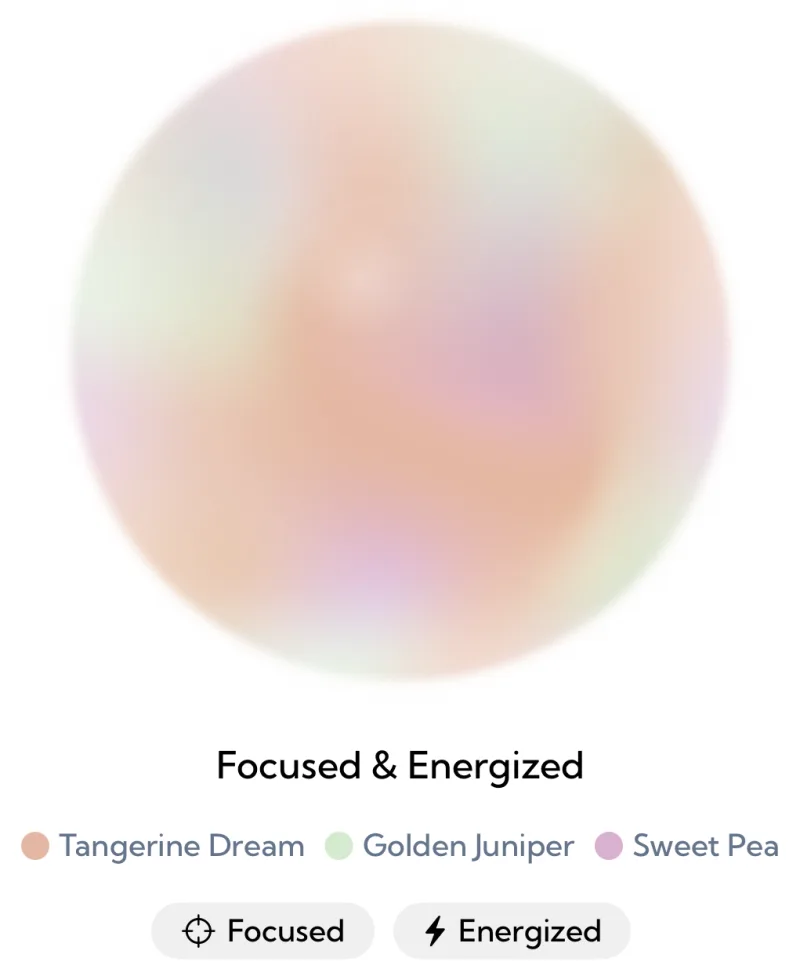 The Aura Color screen in Aura: a large soft sphere in peach, pale green and lilac that fades to near white at its edges, labeled Focused and Energized, above the colors Tangerine Dream, Golden Juniper and Sweet Pea and the mood tags Focused and Energized